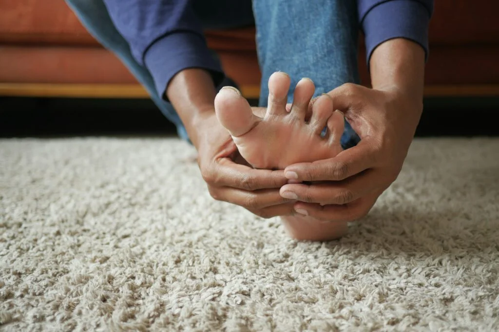 Man holding his foot in pain