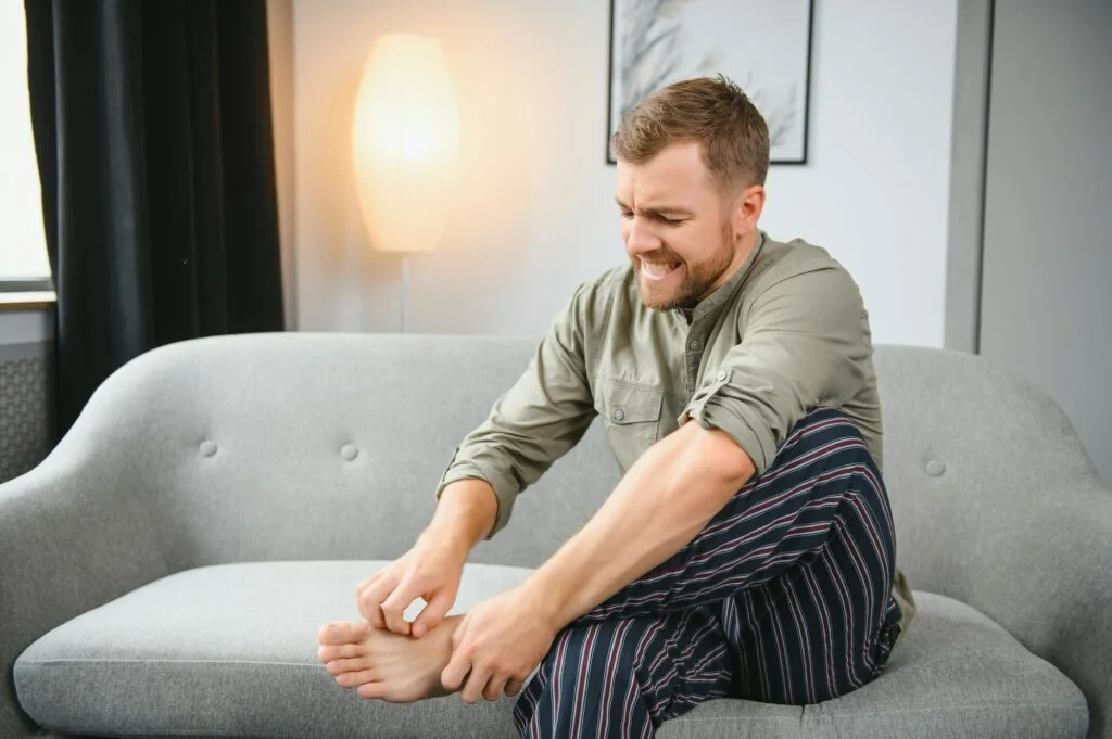 Man scratching his foot